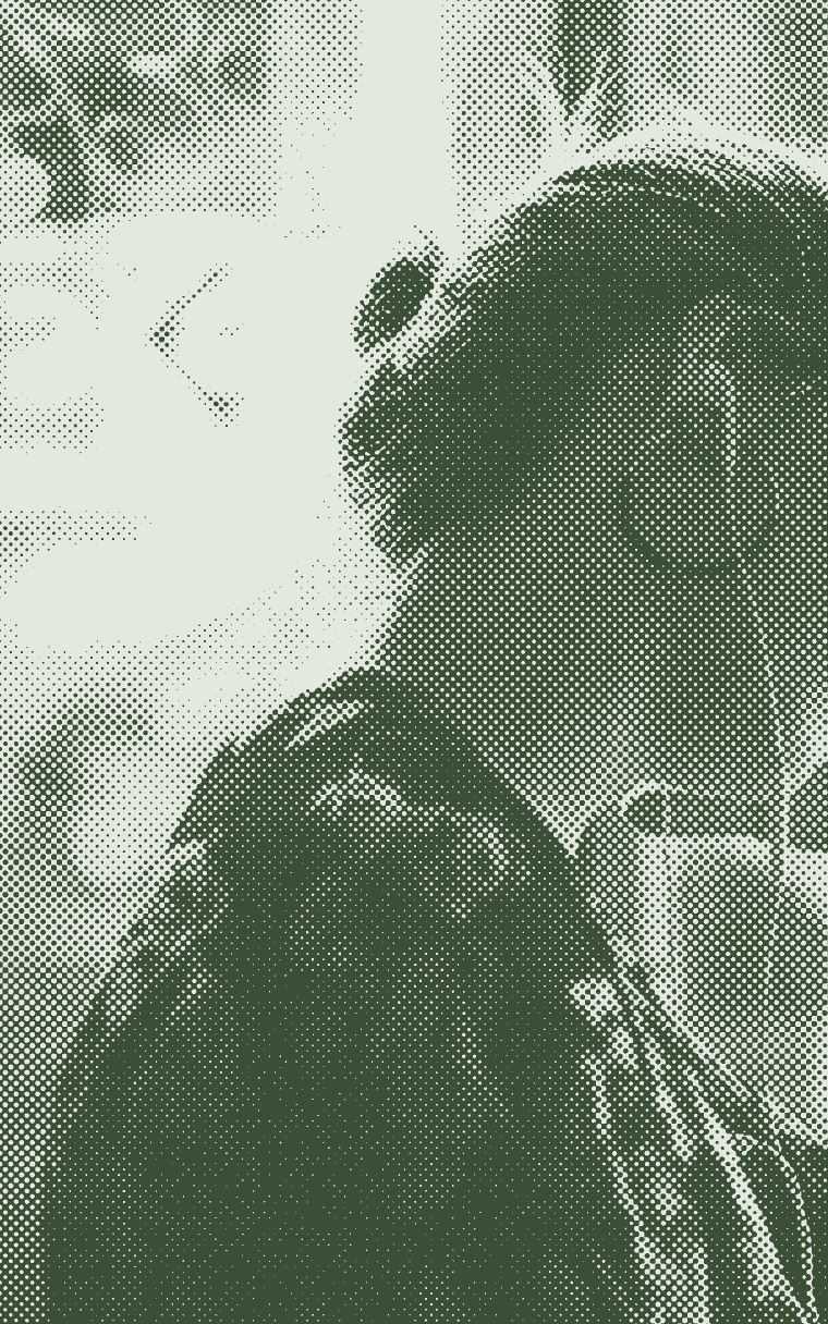 Someone with earphones writing in a cafe