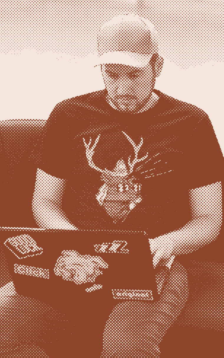 A young man working on a laptop on a couch