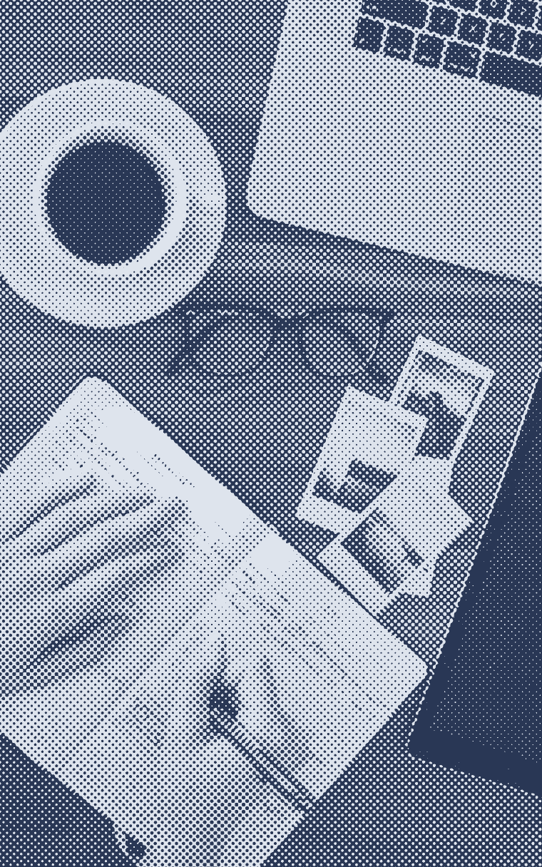 Overhead view of hands journaling next to a laptop and a coffee