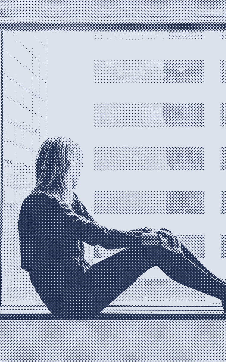 Someone sitting on a wide window sill, looking out over the city